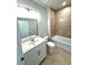This bathroom is equipped with double sinks, a modern vanity, and a tub with shower at 1769 Rowland Pass, Buford, GA 30518