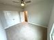 The carpeted bedroom has a double door closet, and a ceiling fan for extra comfort at 1769 Rowland Pass, Buford, GA 30518