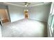 This bedroom includes plush carpeting, a trey ceiling with fan, and ensuite bathroom access at 1769 Rowland Pass, Buford, GA 30518