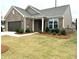 Charming brick home featuring manicured lawn, two-car garage, and stylish exterior finishes at 1769 Rowland Pass, Buford, GA 30518