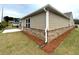 Exterior view features tan siding and brick foundation with manicured landscaping around the house at 1769 Rowland Pass, Buford, GA 30518