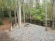 Outdoor fire pit nestled in the woods with a dark wooden fence at 1769 Rowland Pass, Buford, GA 30518
