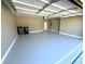 Spacious garage boasts gray painted floors, white trim and an automatic garage door at 1769 Rowland Pass, Buford, GA 30518