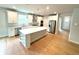 Well-appointed kitchen featuring stainless steel appliances, sleek white cabinets, and center island at 1769 Rowland Pass, Buford, GA 30518