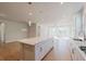 Bright, open kitchen featuring a center island with seating and modern fixtures at 1769 Rowland Pass, Buford, GA 30518