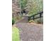 Wood chip path surrounded by lush foliage and a black wooden fence at 1769 Rowland Pass, Buford, GA 30518