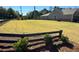 Large, open lot showcasing a well-kept lawn and framed by a classic split-rail fence at 1769 Rowland Pass, Buford, GA 30518
