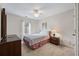 Cozy bedroom features a ceiling fan, bright window, and a comfortable bed and traditional furniture at 1905 Cottage Grove Way, Cumming, GA 30040