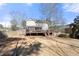 Backyard featuring a deck, fence, and mature trees at 491 Lees Sw Trce, Marietta, GA 30064