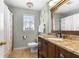 Bathroom with granite vanity, wood cabinets, and a window that provides plenty of natural light at 491 Lees Sw Trce, Marietta, GA 30064
