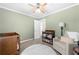 Bedroom with a crib, changing table, and an armchair with good natural light at 491 Lees Sw Trce, Marietta, GA 30064