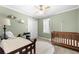 This bedroom has cribs, light green walls, and a ceiling fan providing a calm atmosphere at 491 Lees Sw Trce, Marietta, GA 30064