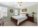 Light-filled bedroom with a bed, a dresser, and two windows with plenty of sunlight at 491 Lees Sw Trce, Marietta, GA 30064