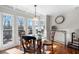 Bright breakfast nook featuring a glass table, hardwood floors, and backyard views at 491 Lees Sw Trce, Marietta, GA 30064
