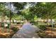 Scenic brick pathway through a peaceful community park with benches and lush greenery at 491 Lees Sw Trce, Marietta, GA 30064