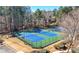 Well-maintained tennis courts for residents, surrounded by lush greenery and trees at 491 Lees Sw Trce, Marietta, GA 30064