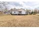 View of the house from the far side of the backyard, showing the expansive lawn at 116 Poplar St, Fairburn, GA 30213