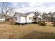 Large backyard showing the back of the house with a chimney and covered back porch at 116 Poplar St, Fairburn, GA 30213
