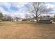 Spacious backyard showing the lot size, with a storage shed and neighborhood houses visible at 116 Poplar St, Fairburn, GA 30213