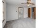 Bedroom boasting a ceiling fan, gray walls, carpeted floors and a doorway leading to another room at 116 Poplar St, Fairburn, GA 30213