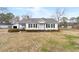 Classic single-story home with a tidy lawn and a detached garage at 116 Poplar St, Fairburn, GA 30213