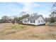 Well-maintained single-story home on a large, grassy lot with mature trees at 116 Poplar St, Fairburn, GA 30213