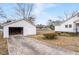 View of detached garage with a concrete driveway and a partial view of the side of the home at 116 Poplar St, Fairburn, GA 30213