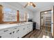 Bright kitchen with white cabinets, stainless steel sink, and a black gas range at 116 Poplar St, Fairburn, GA 30213