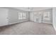 Spacious, freshly painted living room with a ceiling fan, fireplace and ample natural light at 116 Poplar St, Fairburn, GA 30213