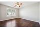 Bright bedroom with hardwood floors, a ceiling fan, a large window and an electrical outlet at 1955 Nichols Landing Way, Dacula, GA 30019