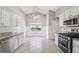 Bright kitchen featuring stainless steel appliances, granite countertops, and tile floors at 1955 Nichols Landing Way, Dacula, GA 30019