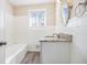 Bright bathroom showcases a modern vanity with granite top, complemented by white tiled walls and flooring at 2917 1St Sw Ave, Atlanta, GA 30315