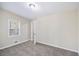 Well-lit bedroom featuring neutral paint, plush carpeting, and a door that opens to additional space at 2917 1St Sw Ave, Atlanta, GA 30315