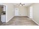 Bright living room boasts modern flooring, neutral paint, and a ceiling fan, adjacent to an open kitchen at 2917 1St Sw Ave, Atlanta, GA 30315
