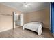 Modest bedroom with an open bathroom, hardwood floors, and a ceiling fan at 400 17Th Street Nw # 1304, Atlanta, GA 30363