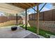 Private backyard patio with modern seating, a retaining wall, and manicured green grass at 1113 Rivard Nw Cir, Atlanta, GA 30318