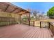 Wooden back deck with a pergola and decorative wooden fencing at 13060 Crabapple Lake Dr, Roswell, GA 30076