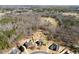 Aerial view of a neighborhood with tree coverage, showcasing the placement of homes within the landscape at 1348 Ewing Creek Dr, Dacula, GA 30019