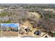 Aerial view featuring a home in a cul-de-sac, alongside lush wooded areas and surrounding homes at 1348 Ewing Creek Dr, Dacula, GA 30019