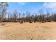 Over an acre with a backyard with mature trees and a perimeter fence for added privacy and security at 1348 Ewing Creek Dr, Dacula, GA 30019
