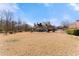 Spacious backyard featuring mature landscaping and partial fencing, perfect for entertaining or enjoying quiet outdoor moments at 1348 Ewing Creek Dr, Dacula, GA 30019