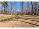 Expansive backyard featuring a small stream and mature trees offering a private, natural setting at 1348 Ewing Creek Dr, Dacula, GA 30019