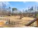 Large, grassy backyard showcasing a well-maintained lawn, mature trees, and a picturesque natural setting at 1348 Ewing Creek Dr, Dacula, GA 30019