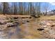 Creek runs through the backyard of this property with mature trees at 1348 Ewing Creek Dr, Dacula, GA 30019