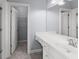 Clean bathroom with a white vanity, large mirror, and access to a closet, providing essential storage and convenience at 1348 Ewing Creek Dr, Dacula, GA 30019