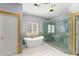 Elegant bathroom featuring a modern tub and separate glass shower at 1348 Ewing Creek Dr, Dacula, GA 30019