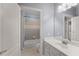 Functional bathroom featuring a tub-shower combo, white vanity, and well-lit mirror, offering a clean and practical space at 1348 Ewing Creek Dr, Dacula, GA 30019