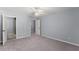 Bedroom featuring neutral carpet, light blue walls and multiple doors at 1348 Ewing Creek Dr, Dacula, GA 30019