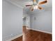 Cozy bedroom featuring hardwood floors, ceiling fan, and white-trimmed doorway at 1348 Ewing Creek Dr, Dacula, GA 30019