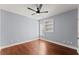 Bedroom featuring hardwood floors, light blue walls, window, and built-in shelving at 1348 Ewing Creek Dr, Dacula, GA 30019